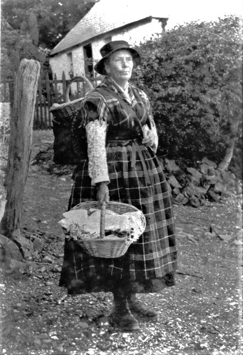 Fisherwoman outside Ferry Bay cottage